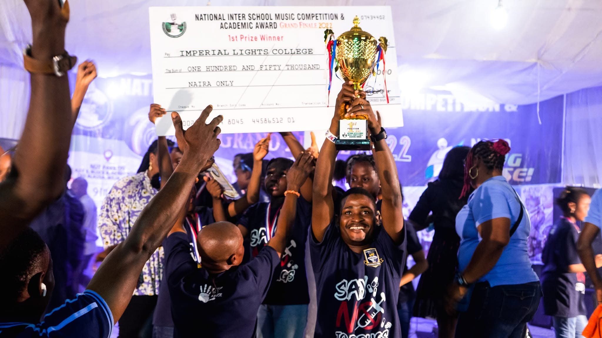 Students celebrating their NISMCAA award on stage